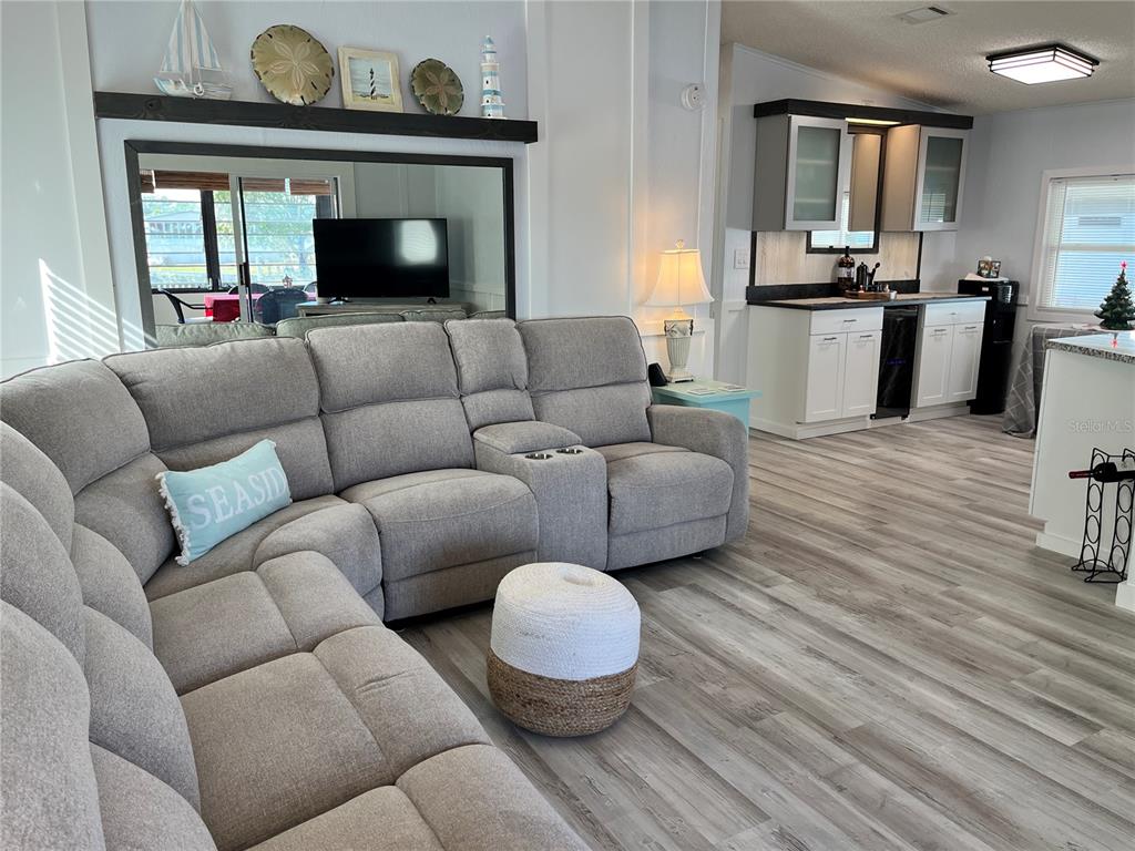 6803 Mt Pleasant Road Northeast, Unit 33 St. Petersburg, FL 33702 - Photo 6 of 28 a living room with furniture and a fireplace