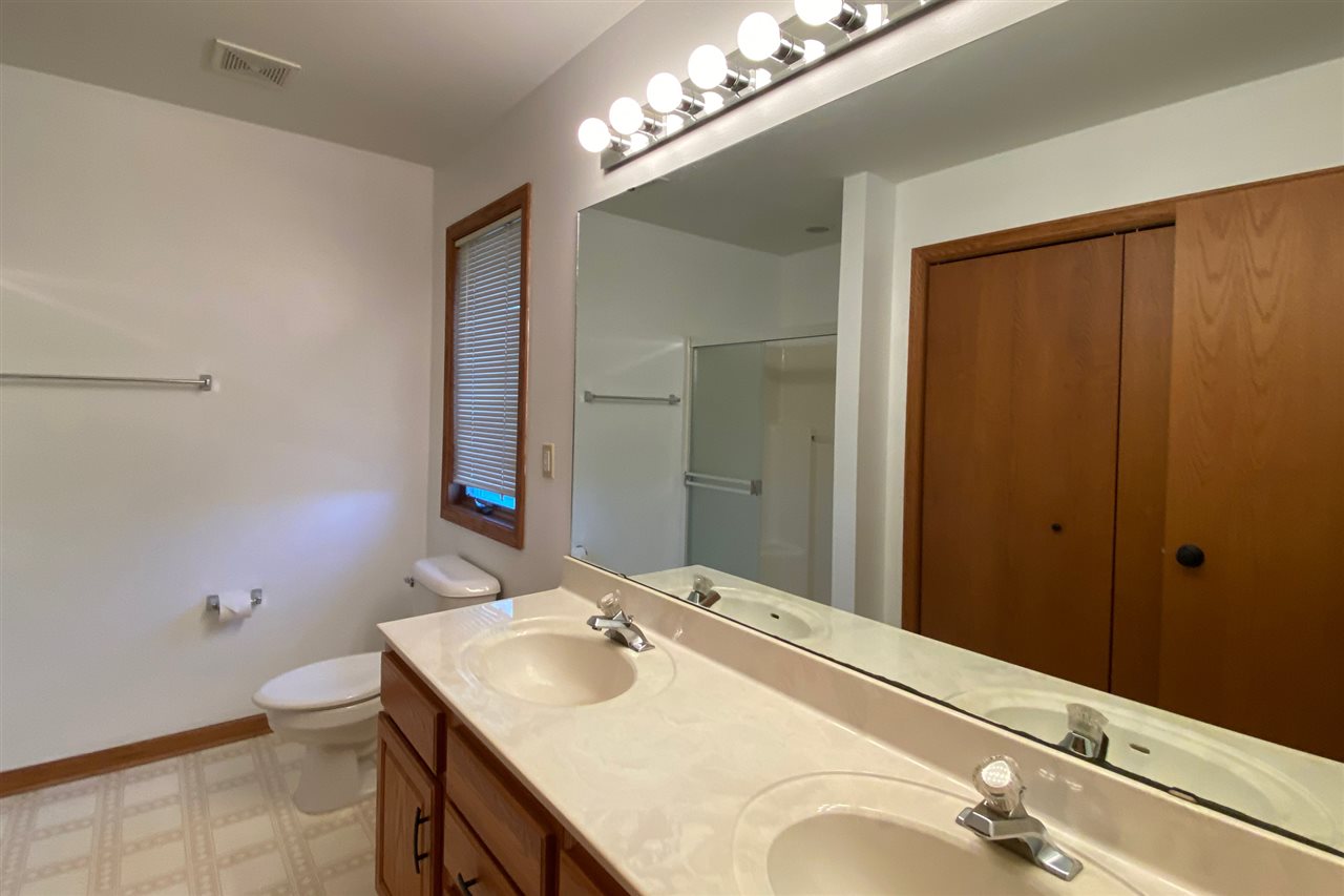 7290 Stephens Road Rockton, IL 61072 - Photo 16 of 30 a bathroom with a sink vanity granite and a mirror