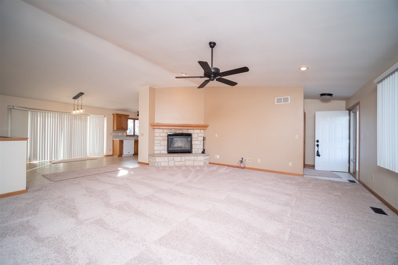 7290 Stephens Road Rockton, IL 61072 - Photo 5 of 30 a view of a livingroom with a fireplace and a ceiling fan