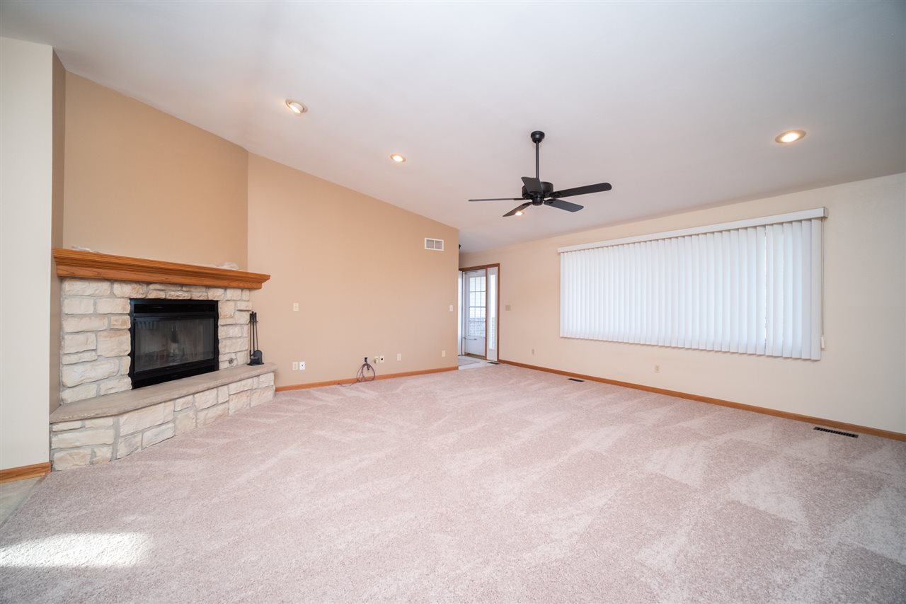 7290 Stephens Road Rockton, IL 61072 - Photo 6 of 30 a view of an empty room with a fireplace and a window