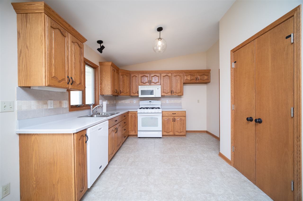 7290 Stephens Road Rockton, IL 61072 - Photo 9 of 30 a large kitchen with stainless steel appliances lots of white cabinets