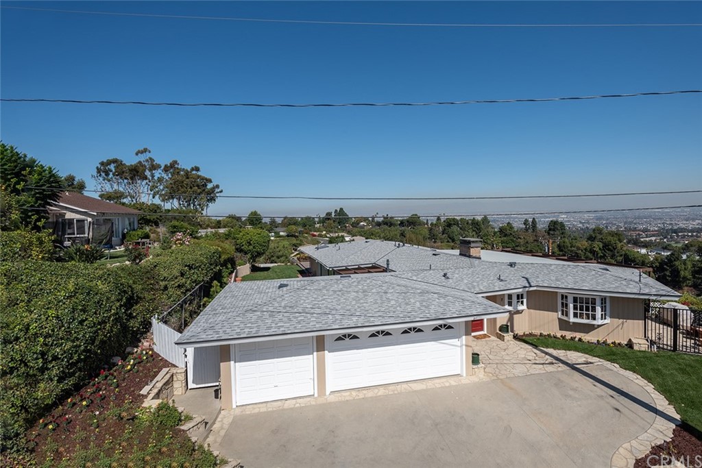 an aerial view of a house with a yard basket ball court and outdoor seating