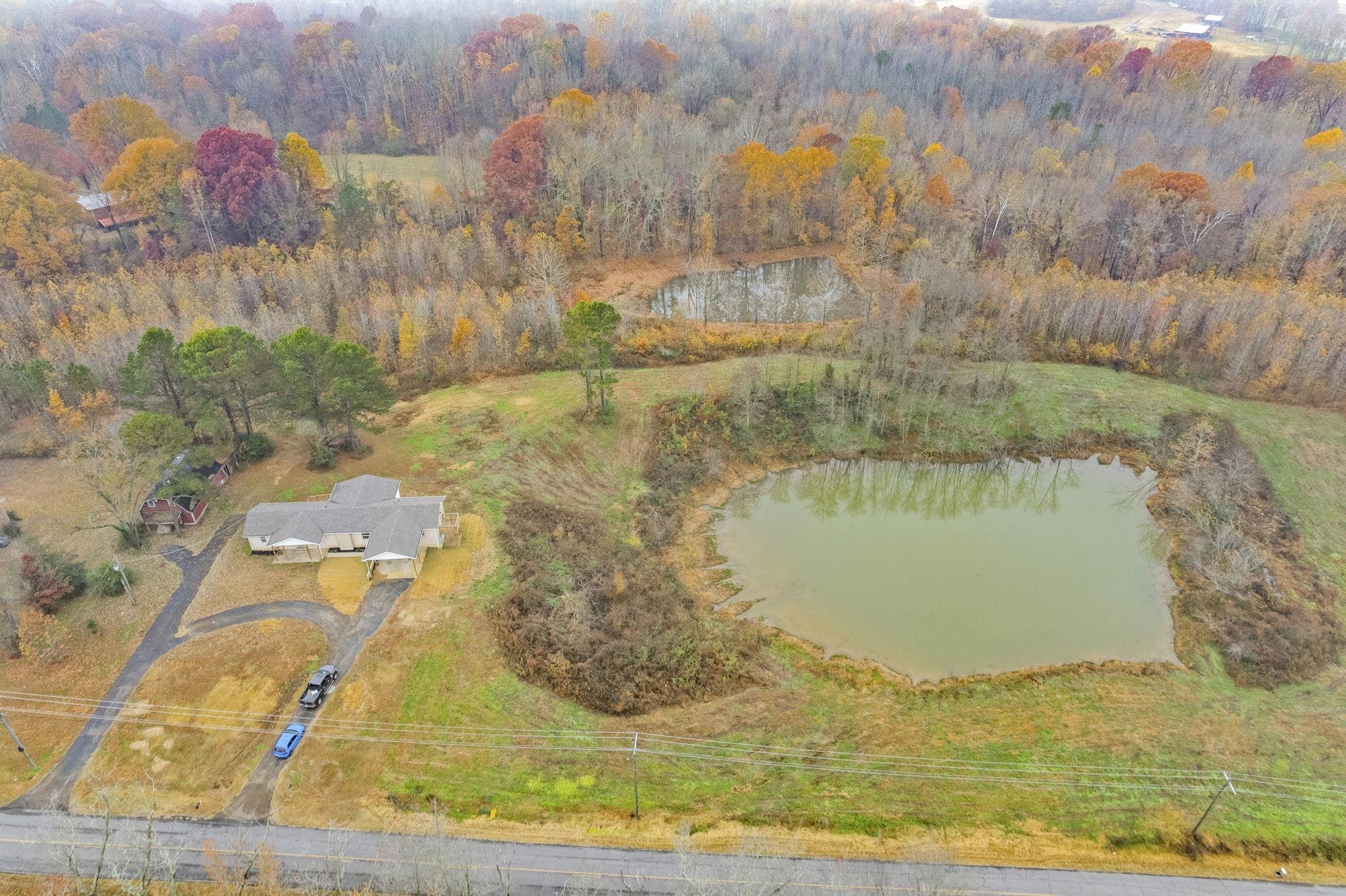835 Curve Woodville Road Gates, TN 38037 - Photo 29 of 30 Aerial view of property's location featuring a nearby body of water and a heavily wooded area