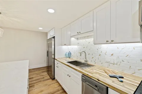 a kitchen with a sink and cabinets
