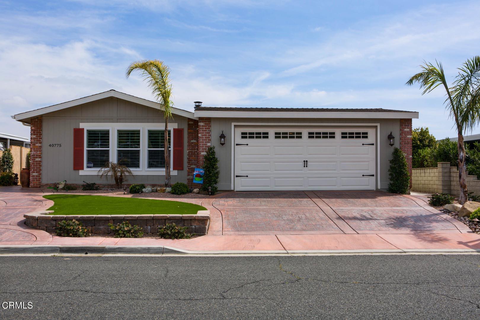 40775 Cheyenne Trail Cherry Valley, CA 92223 - Photo 2 of 21 a front view of a house with a garden and garage