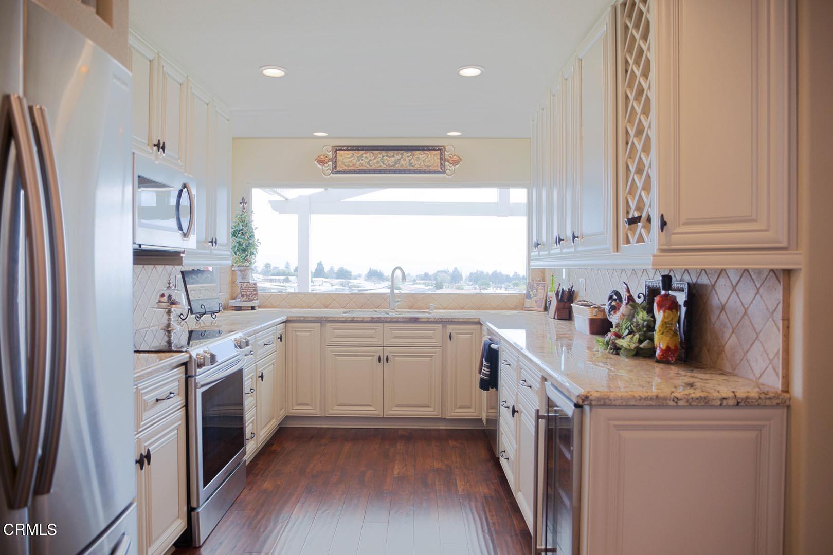40775 Cheyenne Trail Cherry Valley, CA 92223 - Photo 7 of 21 a kitchen with a sink stove and refrigerator