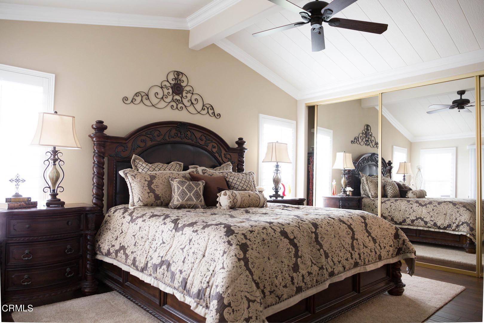 40775 Cheyenne Trail Cherry Valley, CA 92223 - Photo 10 of 21 a bedroom with a large bed and a chandelier