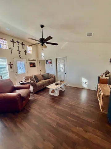 a living room with furniture and a chandelier