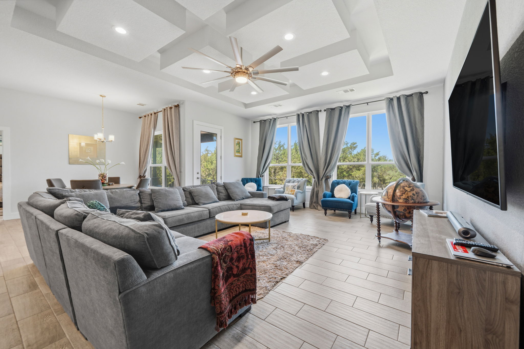 18605 Masters Cove Point Venture, TX 78645 - Photo 10 of 40 Expansive living area featuring a coffered ceiling with recessed lighting and a ceiling fan