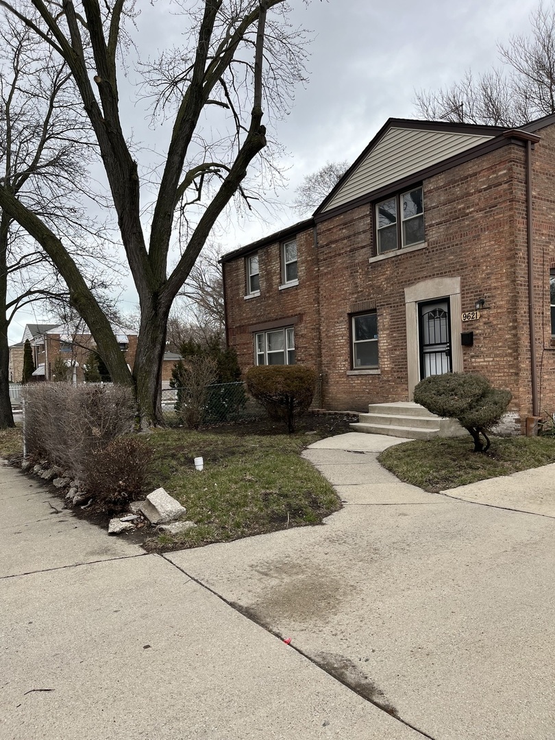 9621 South Yates Boulevard Chicago, IL 60617 - Photo 1 of 6 a front view of a house with a yard and garage