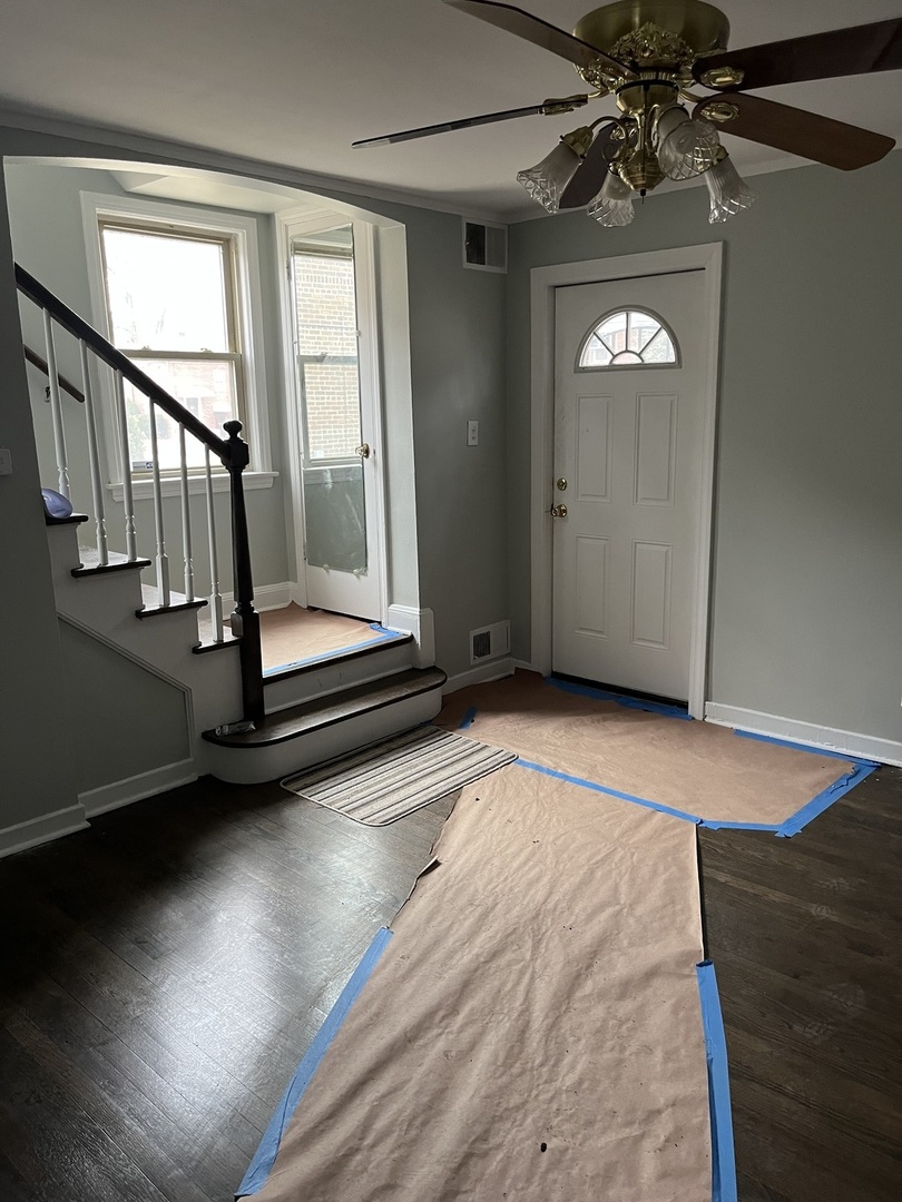 9621 South Yates Boulevard Chicago, IL 60617 - Photo 2 of 6 wooden floor in a hall with a window