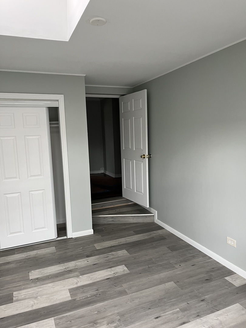 9621 South Yates Boulevard Chicago, IL 60617 - Photo 4 of 6 a view of a livingroom with wooden floor and stairs