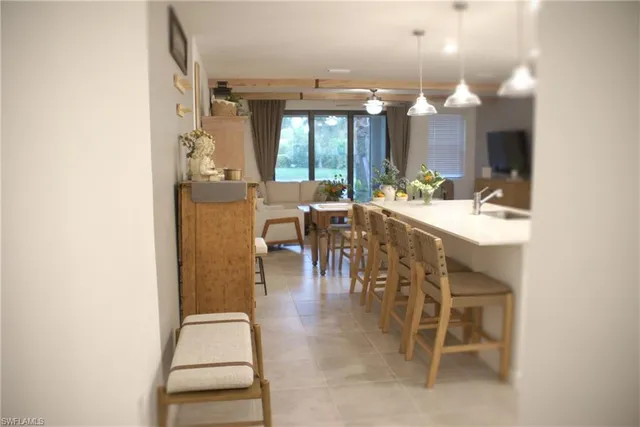 a view of a dining room with furniture and a chandelier fan
