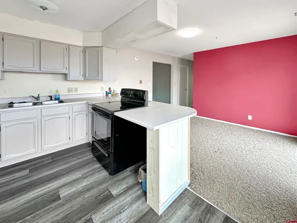 a kitchen that has a sink and a stove in it