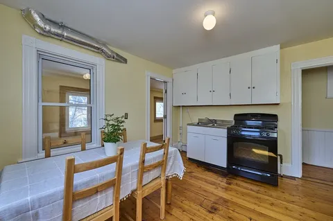 a kitchen with a stove a sink and a refrigerator