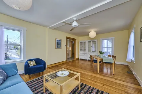 a living room with furniture and wooden floor