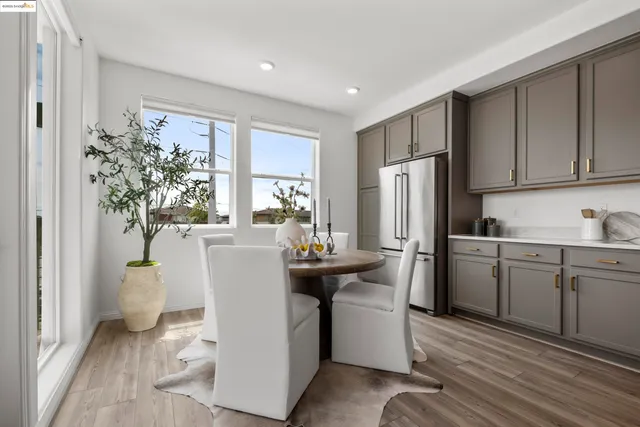 a dining room with furniture and a floor to ceiling window