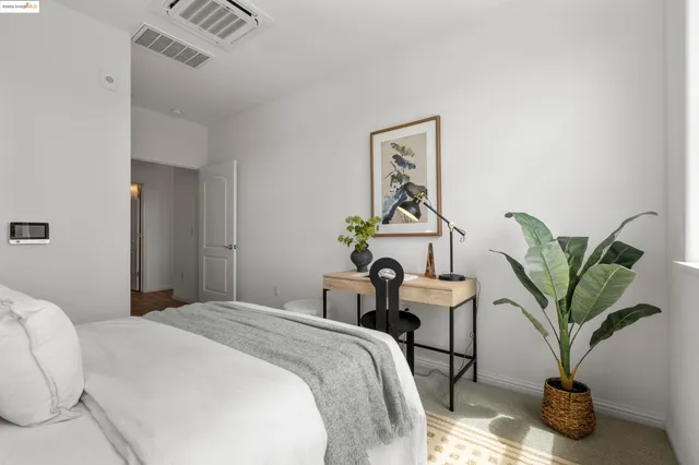 a bedroom with a bed and a large window