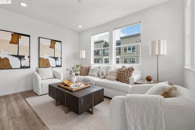 a living room with furniture potted plant and a large window