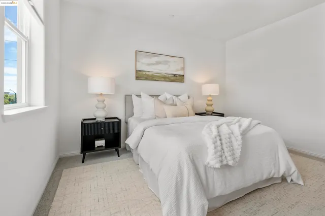 a bedroom with bed and a chair