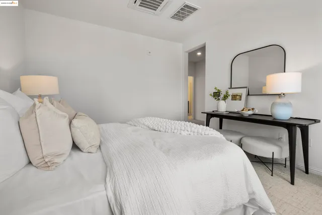 a bedroom with a bed and a lamp