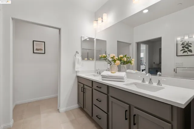 a bathroom with a shower sink and mirror