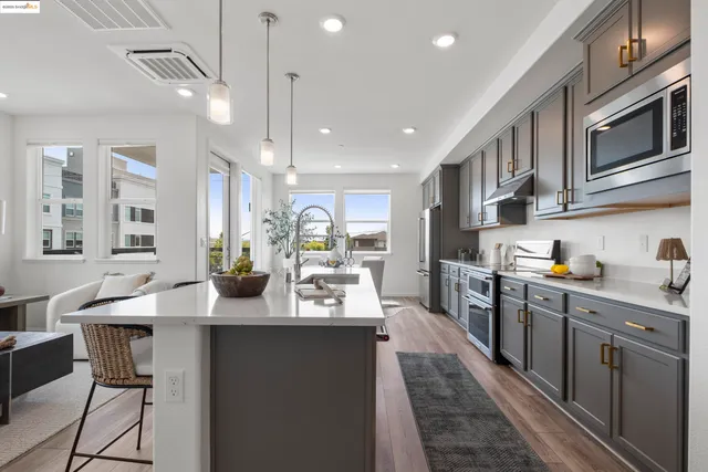 a kitchen with counter top space a sink appliances and cabinets