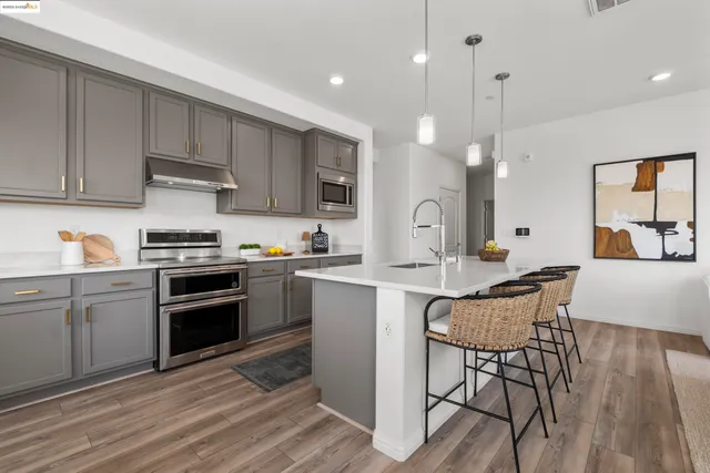 a kitchen with a sink stainless steel appliances and cabinets
