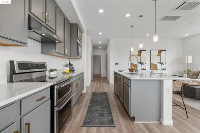 a kitchen with stainless steel appliances granite countertop lots of counter top space a sink and cabinets