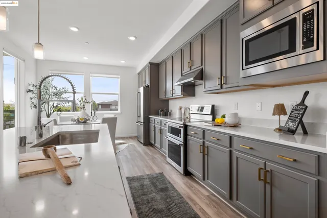 a kitchen with counter top space and wooden floor