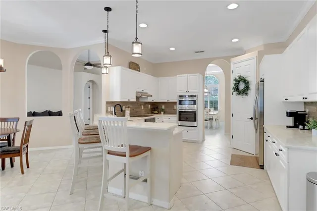 a large kitchen with a table and chairs