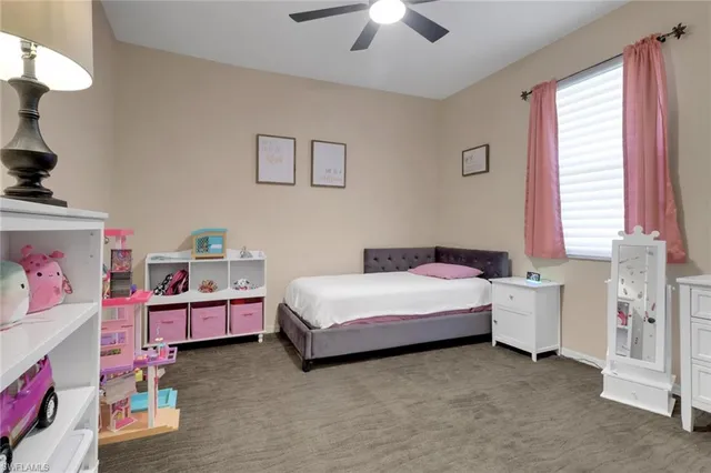 a spacious bedroom with furniture and a baby crib