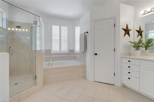 a spacious bathroom with a bathtub and shower