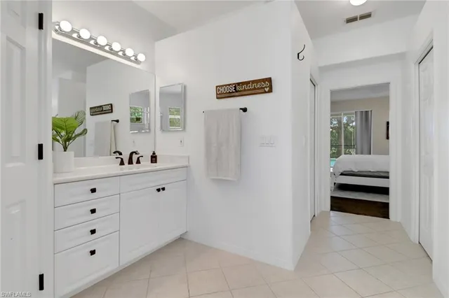 a view of a hallway with closet and mirror