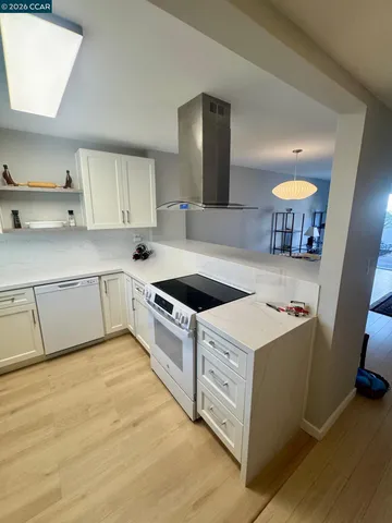 a kitchen with a stove cabinets and window