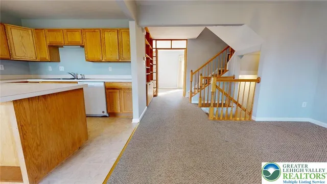 a view of a kitchen with furniture and staircase