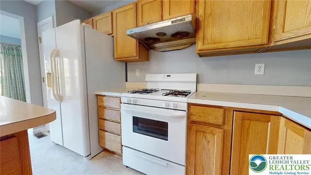 a kitchen with stainless steel appliances granite countertop a stove and a refrigerator