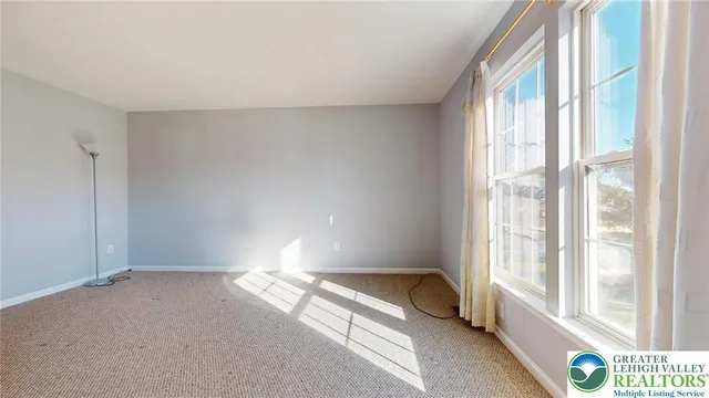 a view of an empty room and a window