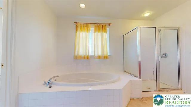 a bathroom with a bathtub and a shower
