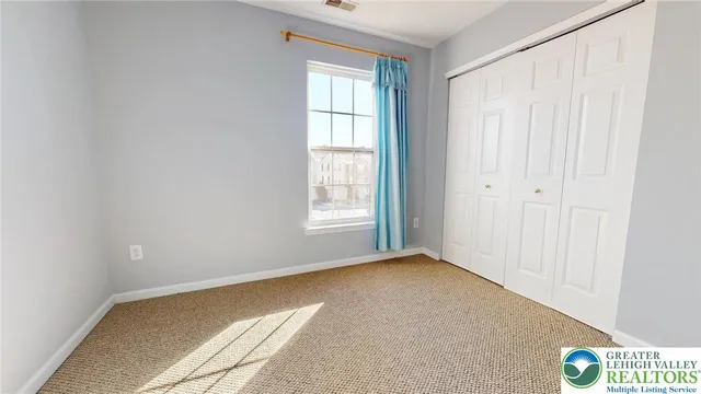 a view of an empty room and a window