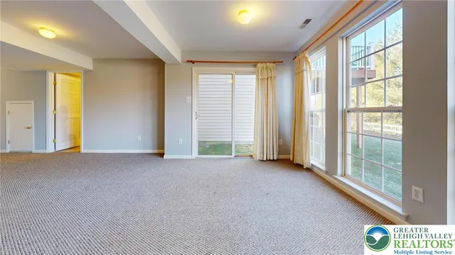 a view of an empty room with windows