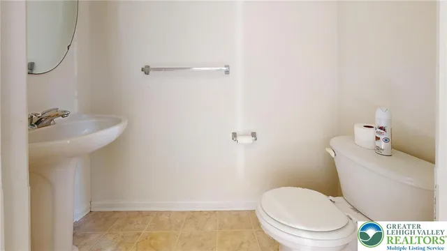 a white toilet sitting next to a bathroom sink