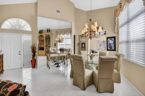 a view of a dining room with furniture and chandelier