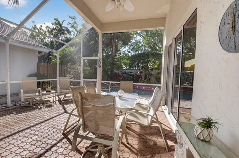 a view of a house with swimming pool and sitting area