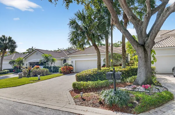 a front view of a house with yard and green space