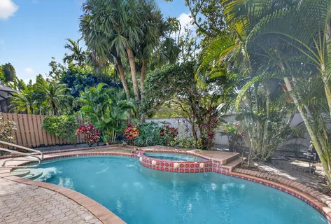 a view of a house with potted plants