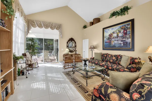 a living room with lots of furniture and a chandelier