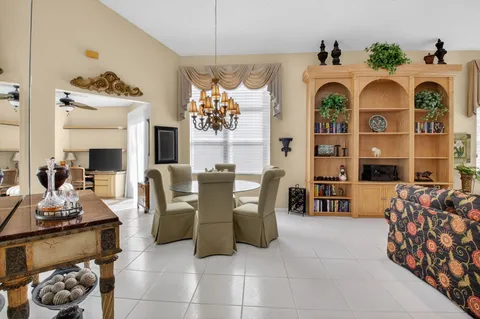 a living room with furniture a rug and a large window