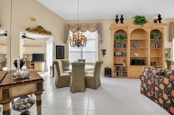 a living room with furniture a rug and a large window