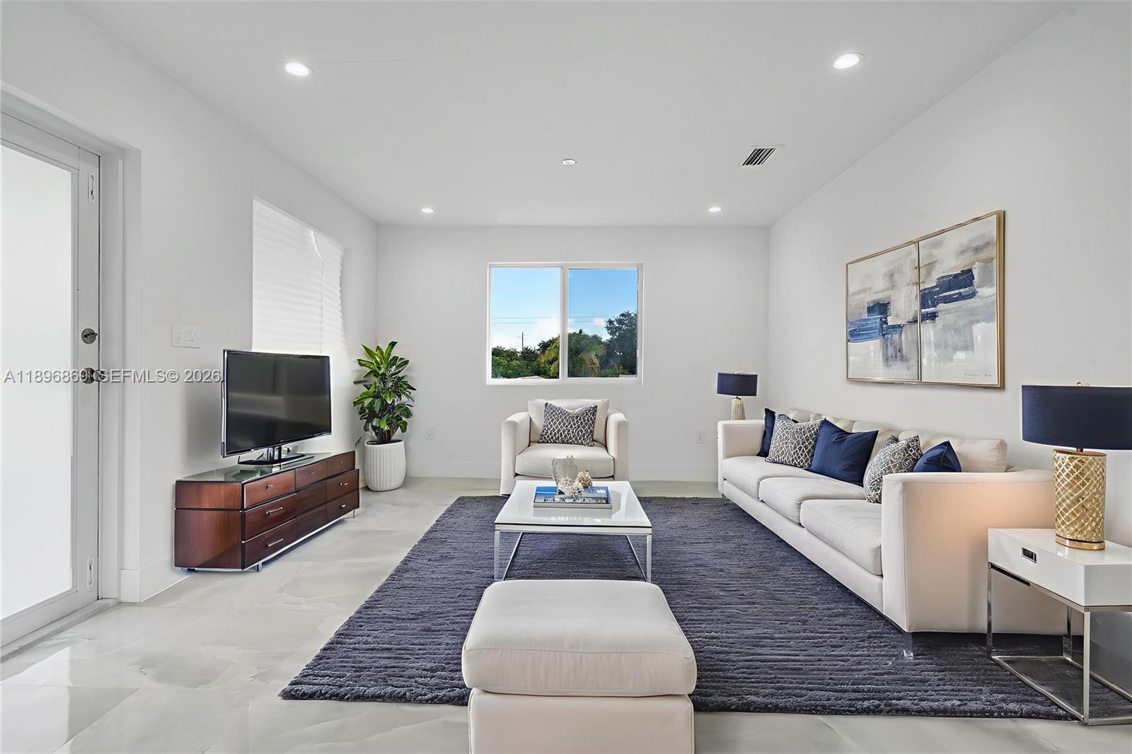 a living room with furniture and a flat screen tv